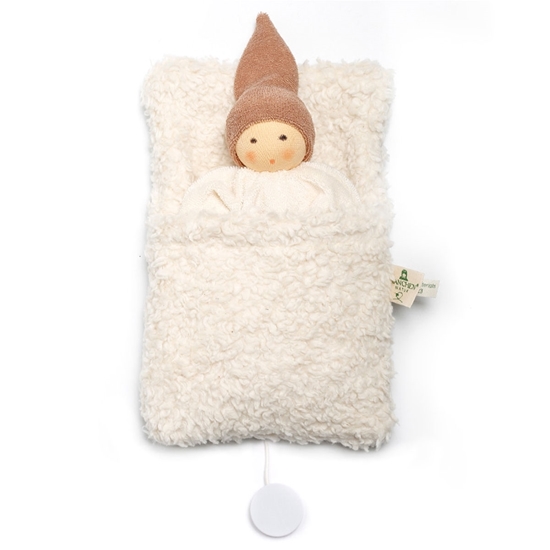 Organic doll sleeping in a off-white cotton fleece sleeping bag that includes a music box.